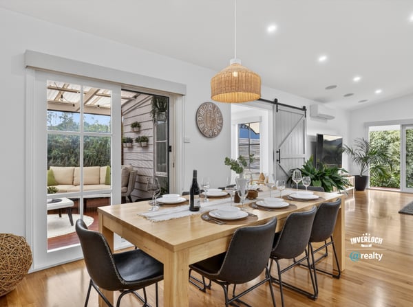 Spacious dining area with natural light, leading to a cozy outdoor retreat for entertaining.