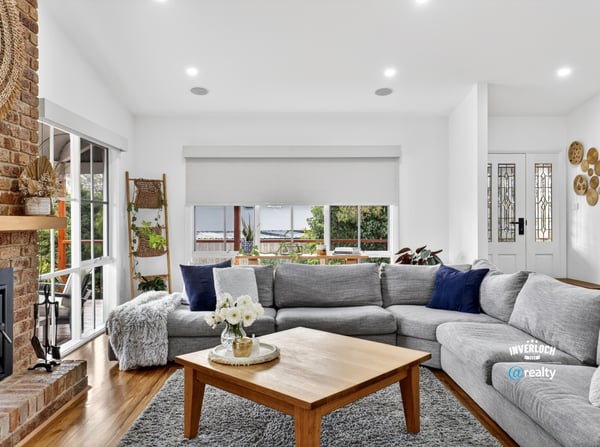 Spacious living area features large windows, offering abundant natural light and a cozy atmosphere.