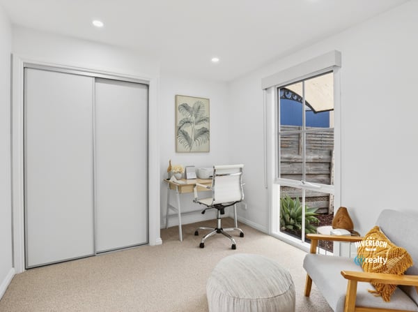 Bright and functional office space featuring natural light, modern furnishings, and streamlined storage solutions for productivity.