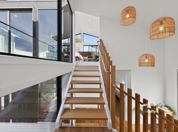 Contemporary design meets natural light in this spacious staircase, highlighting a seamless transition between levels.