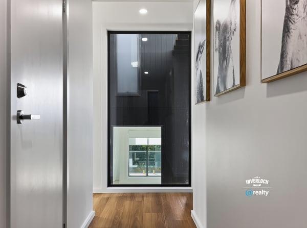Contemporary hallway featuring sleek design and large windows, creating a bright and welcoming entryway.