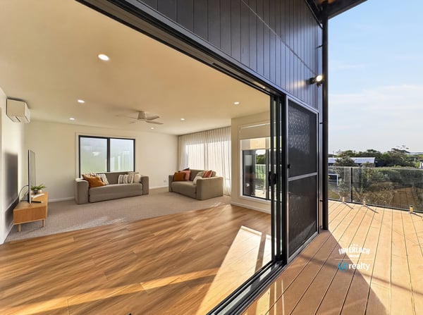 Bright, open living area seamlessly connects to an inviting outdoor deck, perfect for entertaining and relaxation.
