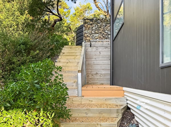 Discover this unique outdoor entrance featuring modern design elements and natural landscaping for easy accessibility.