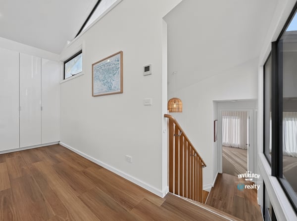 Bright and open foyer with modern design, leading to spacious living areas and stylish staircase.