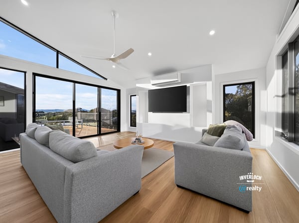 Bright and airy living space featuring large windows that showcase stunning outdoor views and modern design.