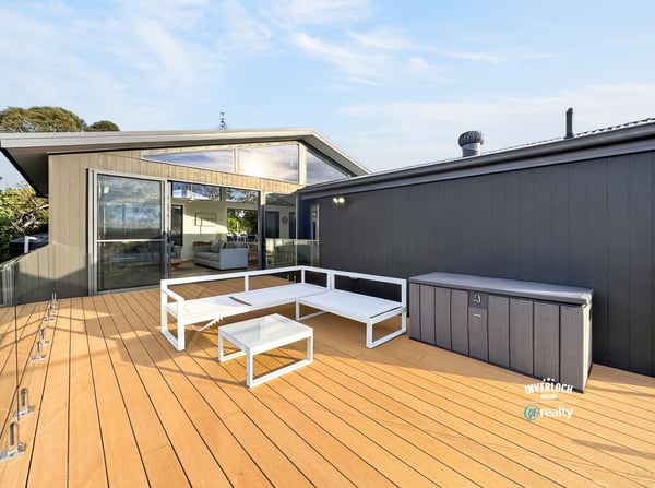 Spacious outdoor deck with modern seating, perfect for entertaining and enjoying views in a contemporary setting.
