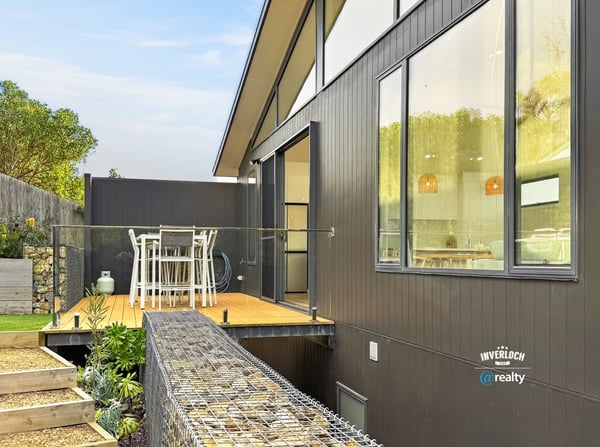Modern home featuring an expansive deck, perfect for outdoor dining and enjoying scenic views.