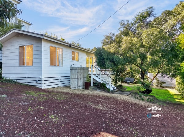 This inviting home features ample natural light, a spacious yard, and a peaceful setting near nature.