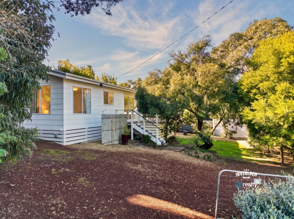 Well-maintained home nestled among lush greenery, featuring ample outdoor space and natural light throughout.
