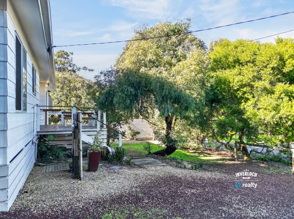 This property features a spacious outdoor area, perfect for relaxation and entertaining amidst lush greenery.