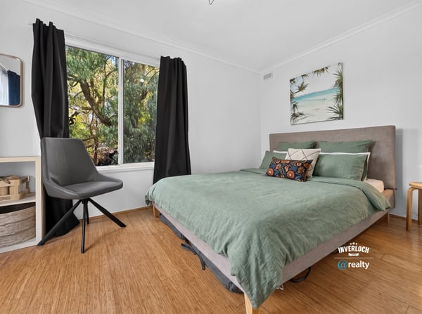 Bright bedroom featuring large window with natural light, contemporary furnishings, and a relaxed, inviting atmosphere.
