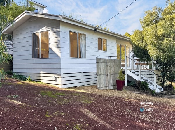 This inviting home features a spacious layout with large windows and a private outdoor area.