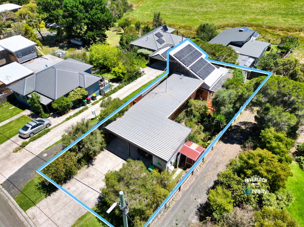 Discover a spacious home with unique architecture, surrounded by lush landscaping and ample outdoor space.