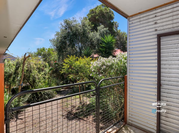 Enjoy a peaceful outdoor space with lush greenery and natural light in this inviting property.