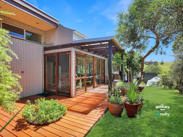 Showcasing a spacious deck surrounded by lush greenery, this property offers a perfect outdoor retreat.
