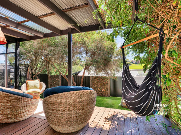 Inviting outdoor space with comfortable seating and a hammock, perfect for relaxation and entertaining.