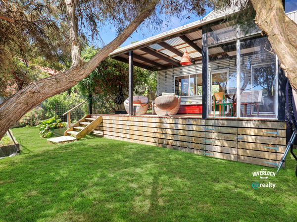 Bright and inviting outdoor space featuring a spacious deck, ideal for relaxation and entertaining.