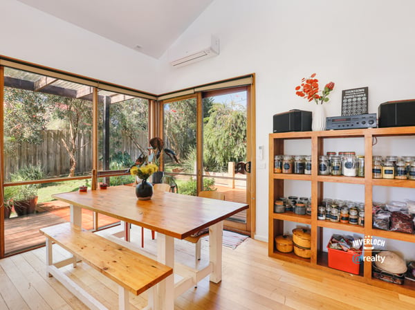 Bright dining space featuring natural light, an open layout, and direct access to a lush outdoor area.