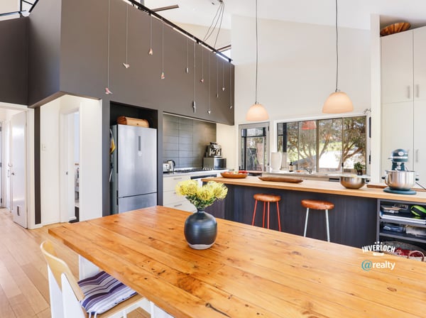 Modern kitchen featuring a spacious island, sleek appliances, and ample natural light for vibrant gatherings.