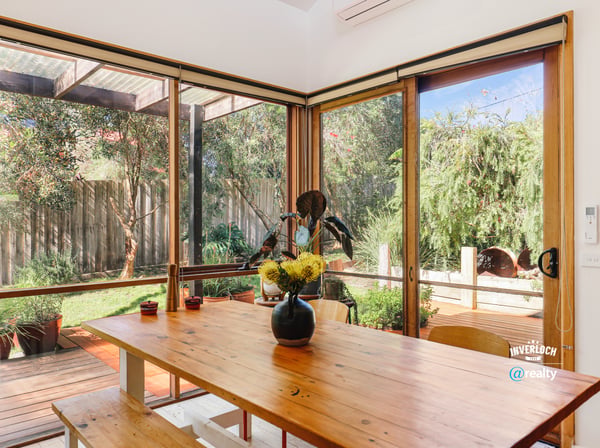 Bright indoor-outdoor living space featuring abundant natural light and a peaceful garden view.