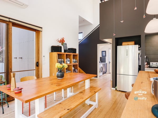 Modern kitchen with open layout, featuring natural light, wooden accents, and a functional design for gatherings.