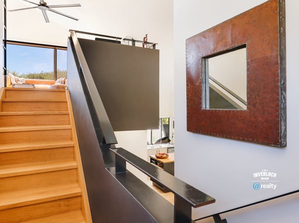 Modern staircase leads to an airy retreat with expansive views and contemporary design details.