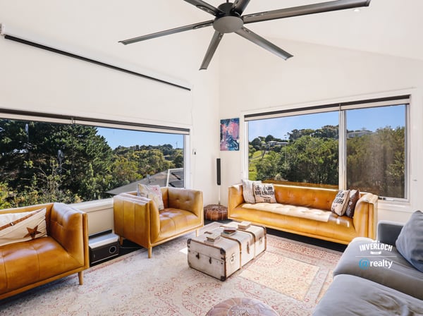 Bright and spacious living area featuring large windows, modern furnishings, and scenic views of nature.
