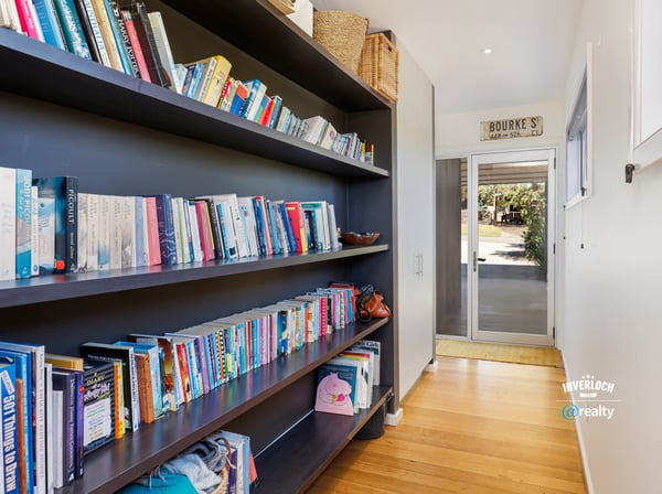 Bright hallway featuring built-in bookshelves, perfect for displaying your favorite reads and personal touches.