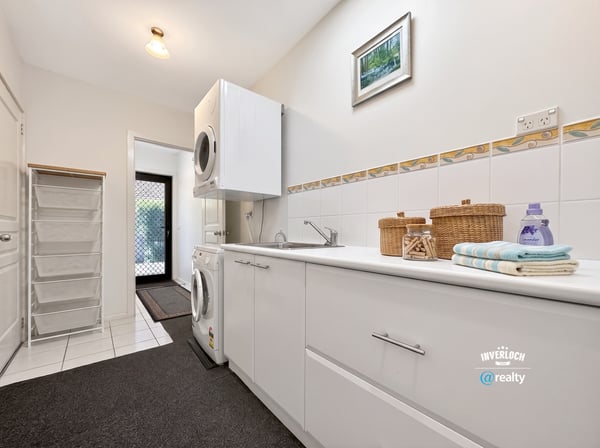 Bright and functional laundry room featuring modern appliances and ample storage for all your needs.