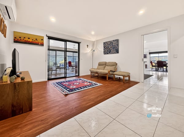 Spacious living area seamlessly connects to a bright, inviting outdoor space perfect for gatherings.