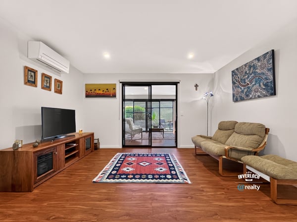 Bright living area with modern amenities, featuring large windows that invite natural light and outdoor views.