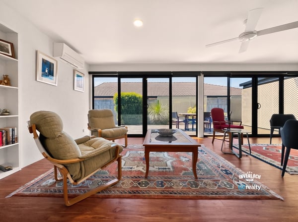 Bright, open living space featuring large windows, versatile furnishings, and a spacious outdoor view.