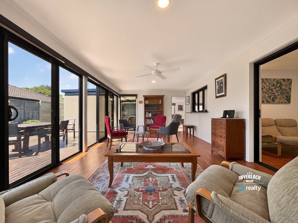 Bright and airy living space featuring large windows, comfortable seating, and a view of the outdoors.