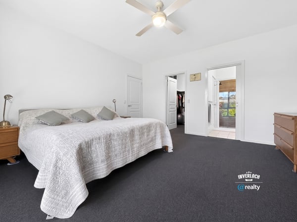 Spacious bedroom featuring ample natural light and direct access to adjoining rooms for added convenience.