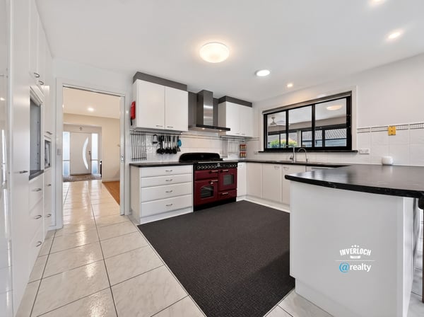 Modern kitchen featuring ample cabinetry, a spacious layout, and sleek appliances, perfect for culinary enthusiasts.