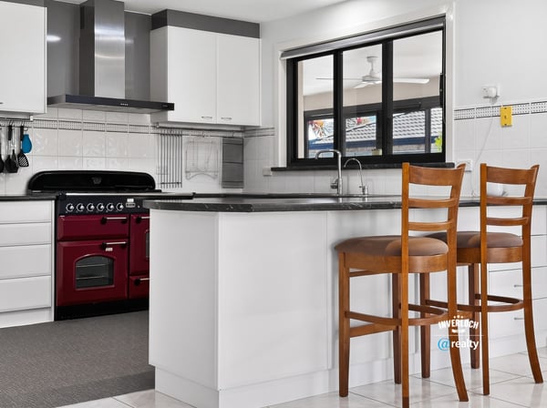 Modern kitchen featuring sleek appliances, ample counter space, and a cozy breakfast bar for casual dining.