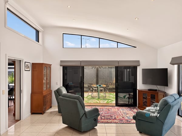 Bright living area featuring large windows, access to the outdoor space, and modern amenities for comfort.