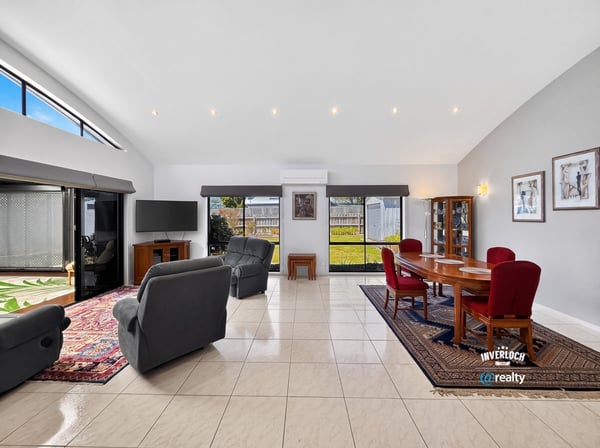 Spacious living area featuring abundant natural light, ideal for both relaxation and entertaining.