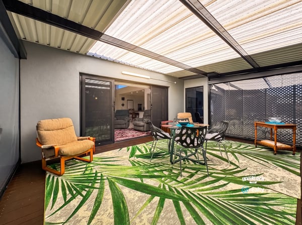 Spacious outdoor patio perfect for gatherings, featuring comfortable seating and vibrant tropical decor.