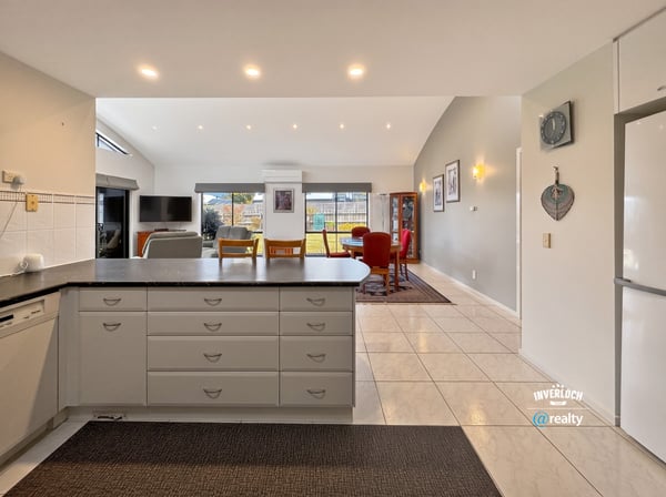 Spacious kitchen and living area with ample natural light, perfect for comfortable family gatherings and entertaining.