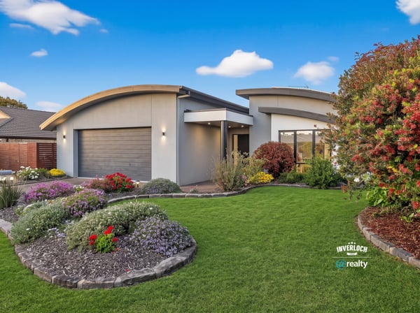 Contemporary home with unique architecture, vibrant landscaping, and a spacious outdoor area for entertaining.