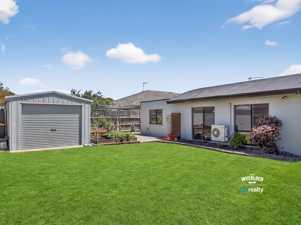 Discover this inviting home with a spacious lawn and a convenient shed, perfect for outdoor activities.