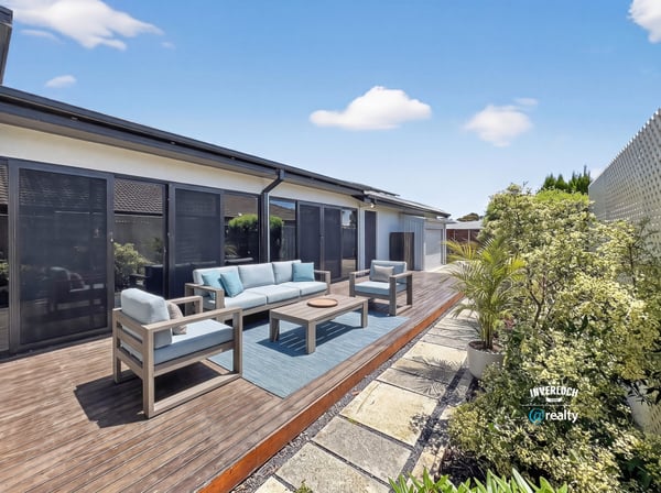 Discover a spacious outdoor area perfect for gatherings, featuring comfortable seating and lush landscaping.