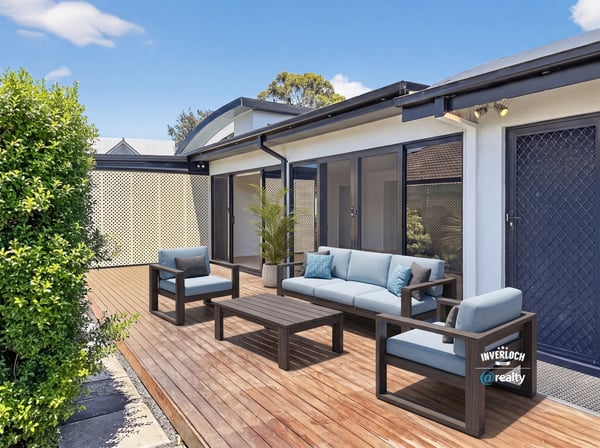 Spacious outdoor living area features modern seating and ample sunlight, perfect for relaxation and entertaining.