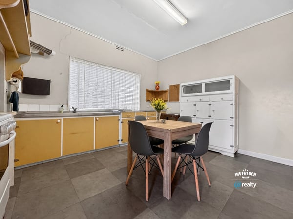 Bright, functional kitchen featuring ample storage and a cozy dining area, perfect for everyday meals.