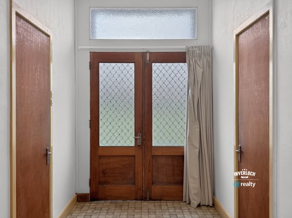 Bright entryway featuring distinctive glass doors and abundant natural light, welcoming you into the home.