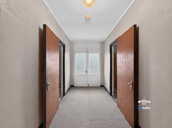 Spacious entrance featuring double doors, leading to sunlit rooms and versatile layout opportunities.