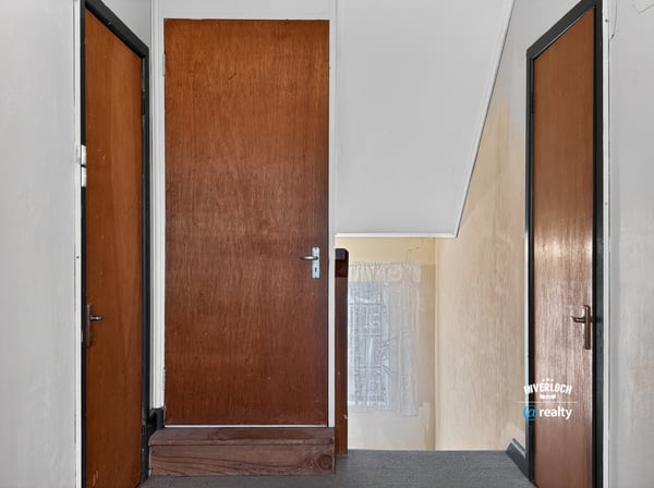 This inviting upper hallway features ample natural light and access to multiple rooms for convenience.