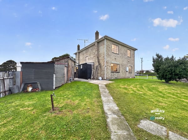 Spacious two-story home with a large yard, ideal for customization and outdoor activities.