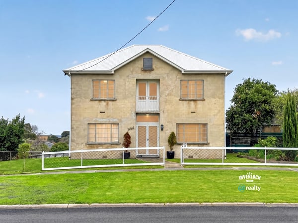 Spacious two-story home with ample yard space, perfect for customization and outdoor living.